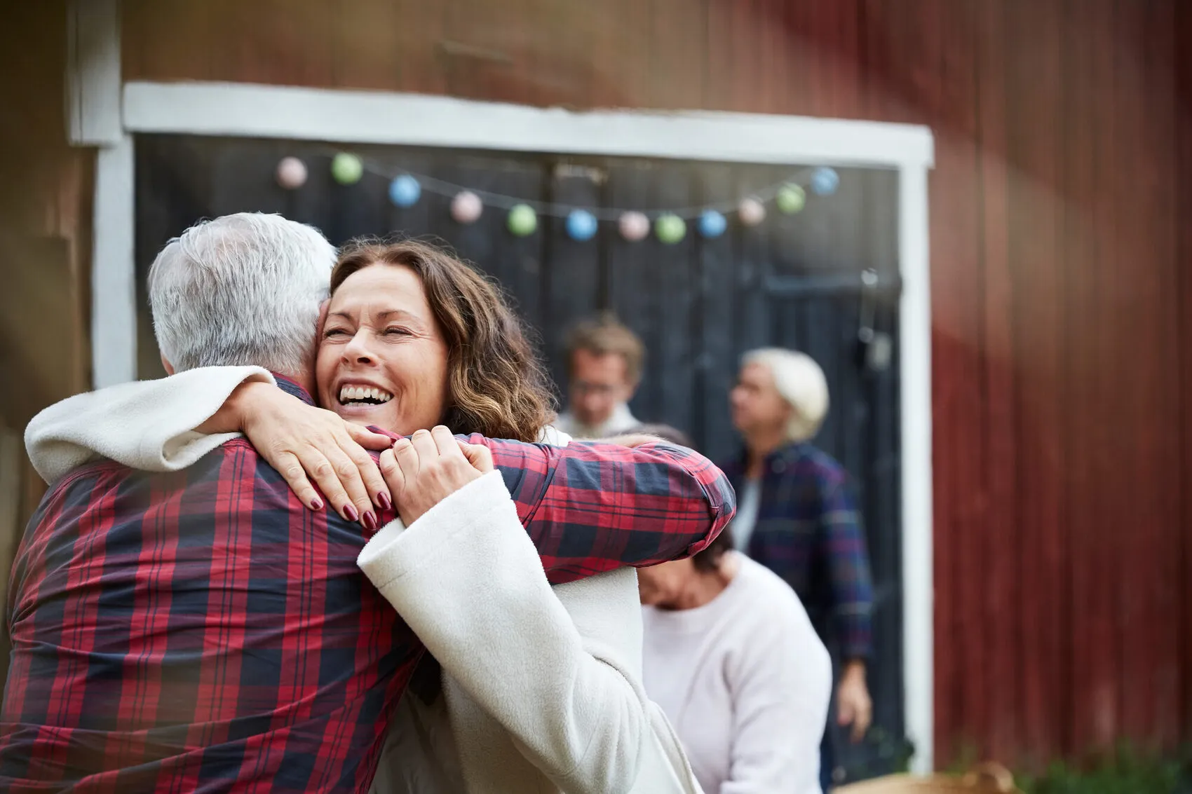 A family joyfully welcoming a senior loved one home with a warm hug in East King County