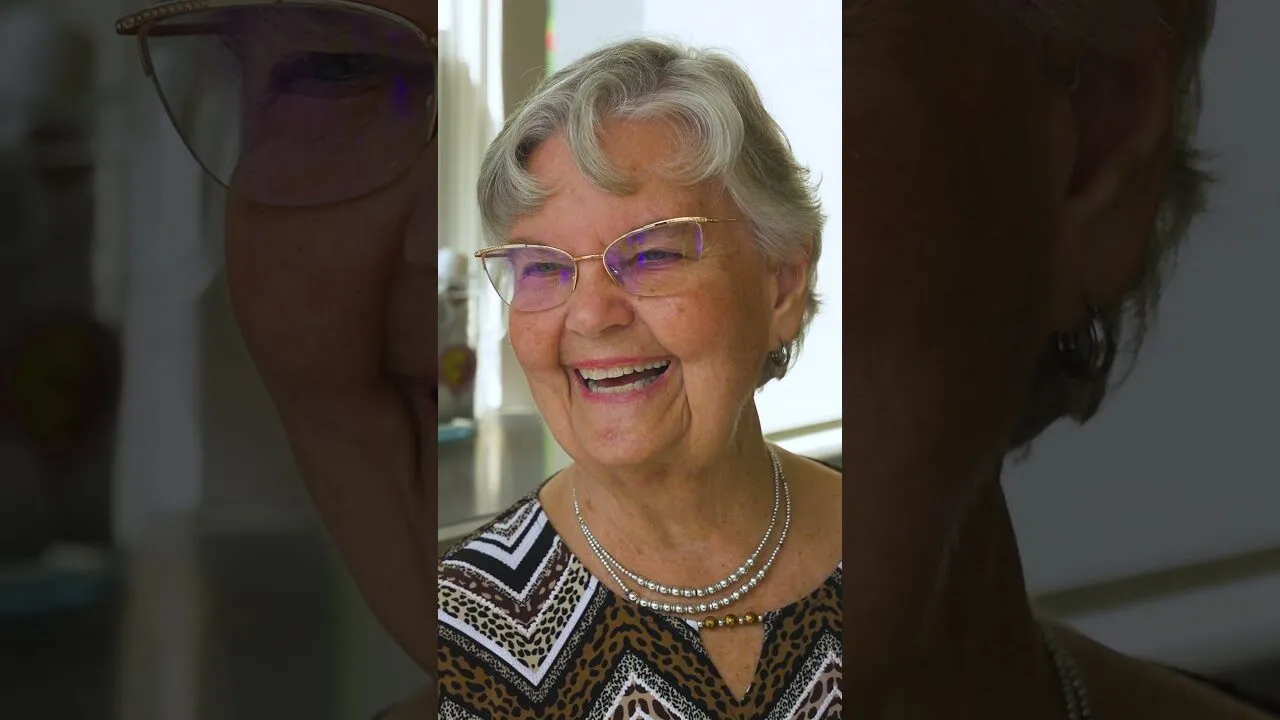 A smiling SYNERGY HomeCare client — play the video to hear from local families