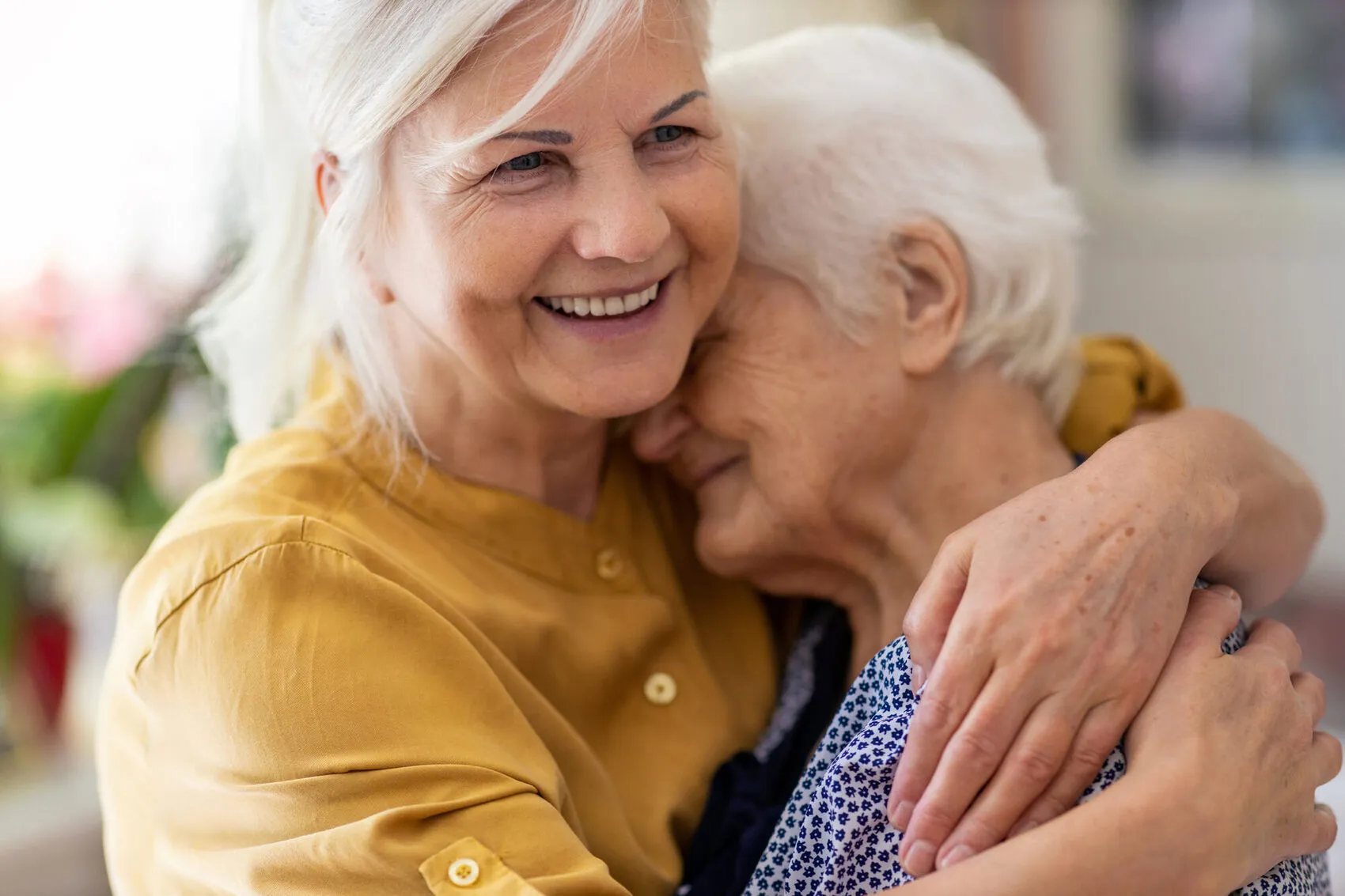 A caregiver assisting a senior recovering comfortably at home after a hospital stay