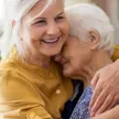 A caregiver assisting a senior recovering comfortably at home after a hospital stay