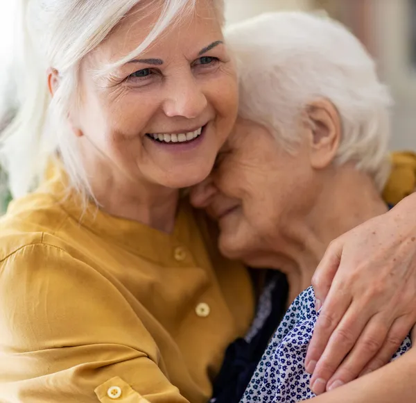 A caregiver assisting a senior recovering comfortably at home after a hospital stay