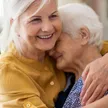 A caregiver assisting a senior recovering comfortably at home after a hospital stay