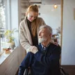 A SYNERGY HomeCare caregiver in a thoughtful consultation with a senior client about memory care