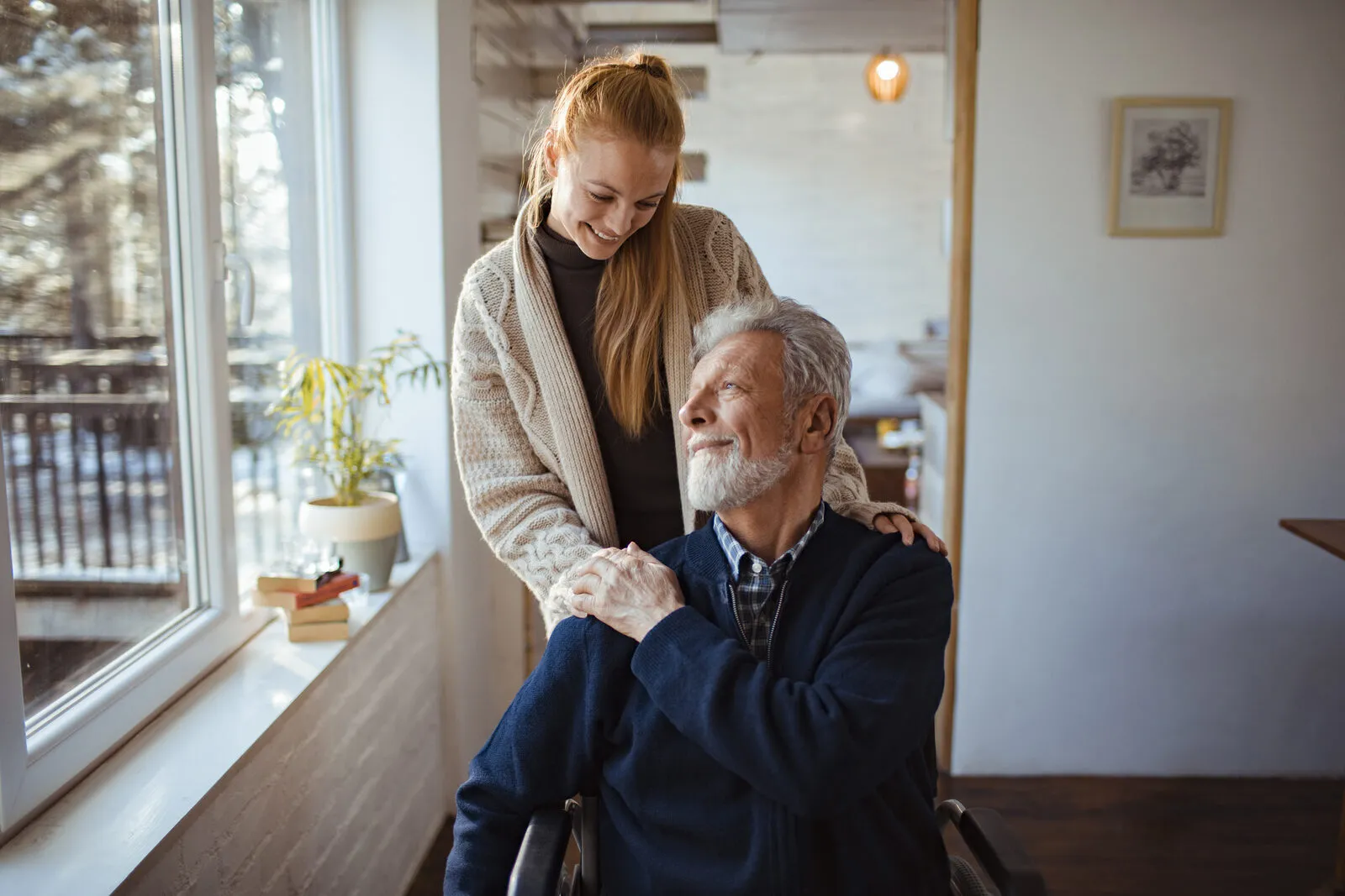 A SYNERGY HomeCare caregiver in a thoughtful consultation with a senior client about memory care