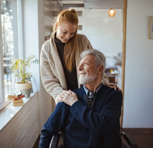 A SYNERGY HomeCare caregiver in a thoughtful consultation with a senior client about memory care